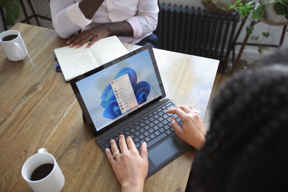Business professionals collaborating with Microsoft 365 and Google Workspace on a laptop